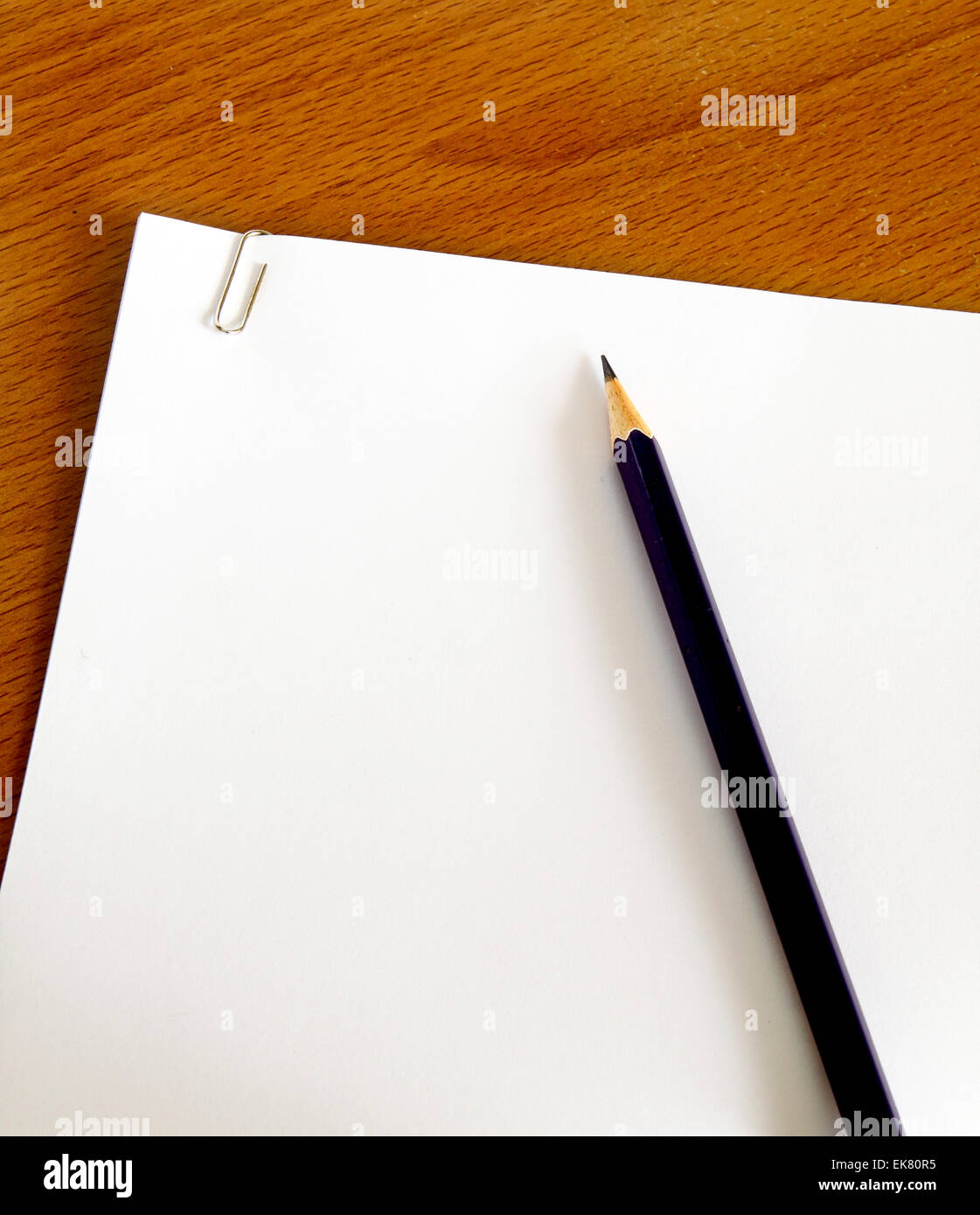 white paper with pencil on table Stock Photo