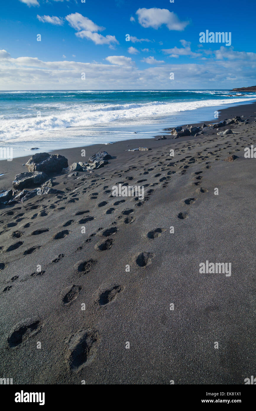exotic-beach-with-black-sand-and-footprints-stock-photo-alamy