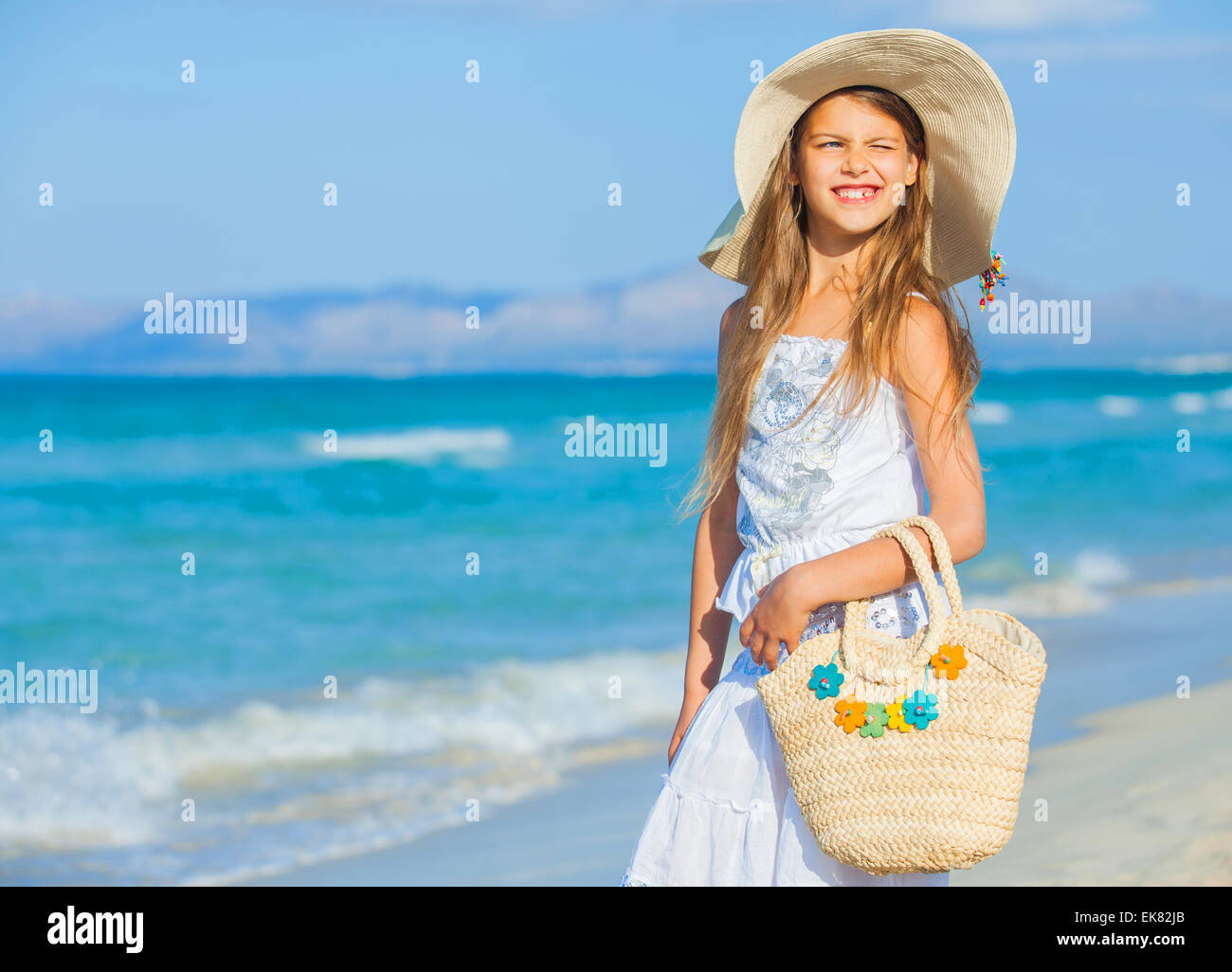 Adorable girl wearing elegant hat on the beach Stock Photo - Alamy