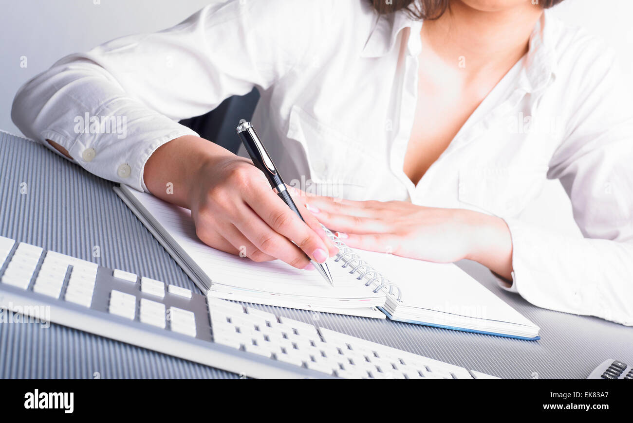 Office Assistant writing Schedule Stock Photo