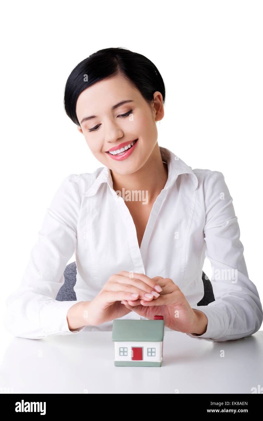 Beautiful businesswoman with house model Stock Photo - Alamy