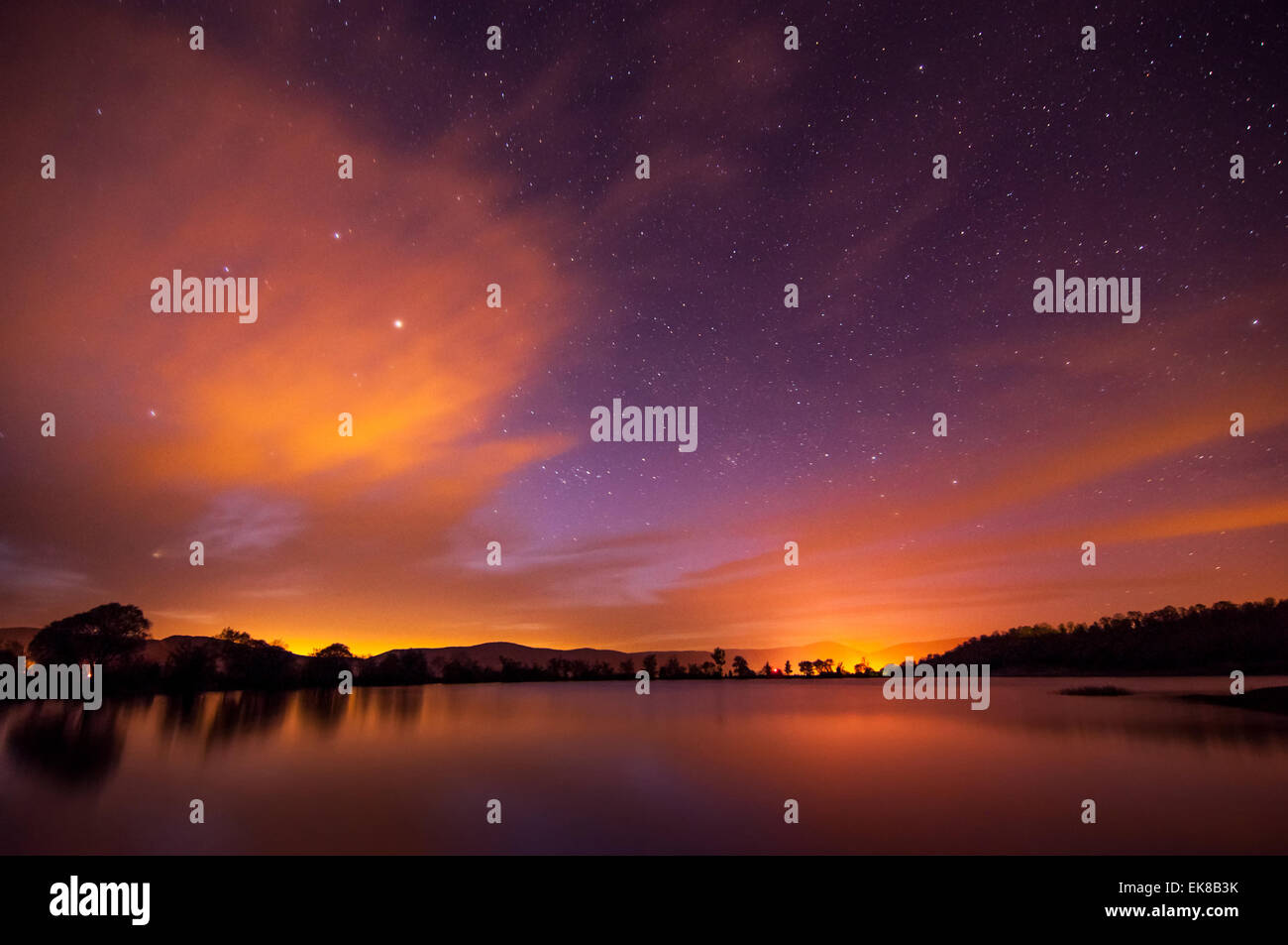 Beautiful spring night on the pond  with stars, clouds and reflection in Crimea Stock Photo