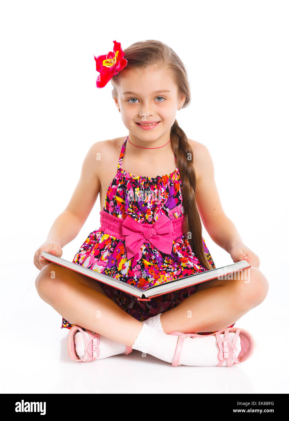 Happy little girl with book Stock Photo - Alamy