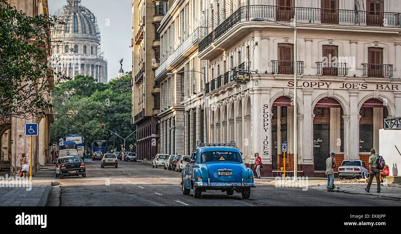 Old Blue American car in front of Sloppy Joe's Bar and the Capitolio building in Old Havana in Cuba Stock Photo