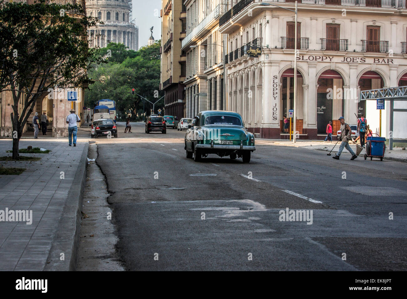 Old American green car in front of Sloppy Joe's Bar and the Capitolio building in Old Havana in Cuba Stock Photo