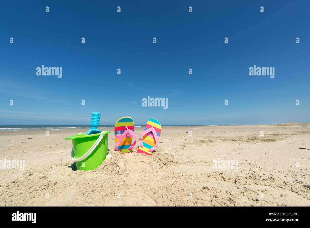 Beach for vacation with flip flops toys and drinks Stock Photo - Alamy