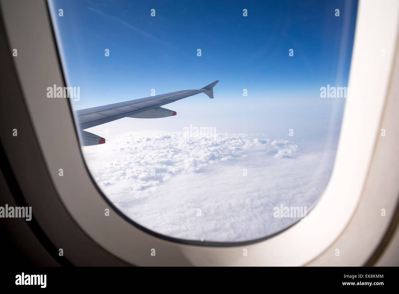 Airplane wing seen through plane window Stock Photo