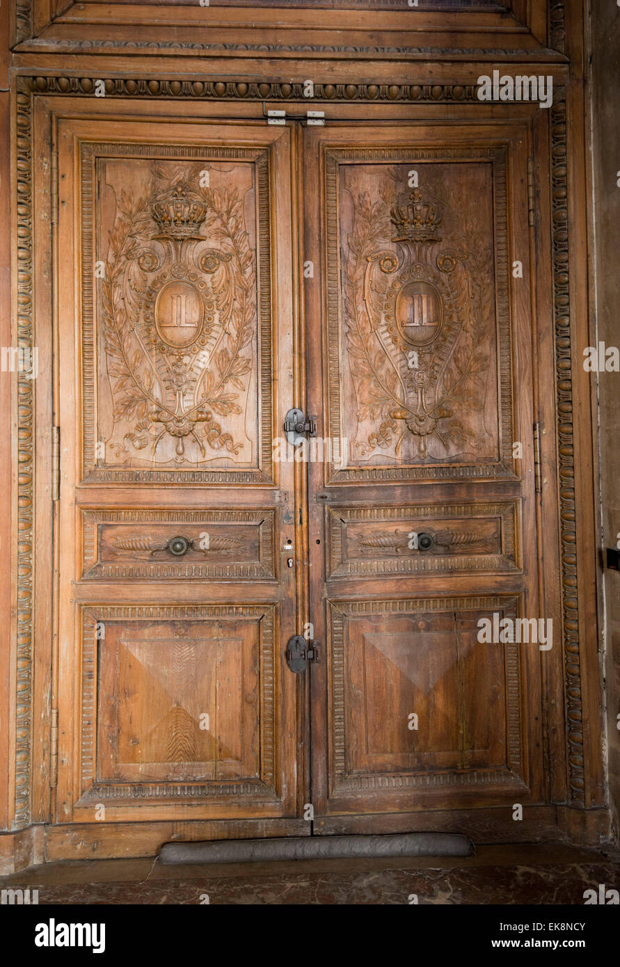 A large old wooden door in the Louvre Museum (Musee du Louvre) in Paris, France Europe EU Stock Photo