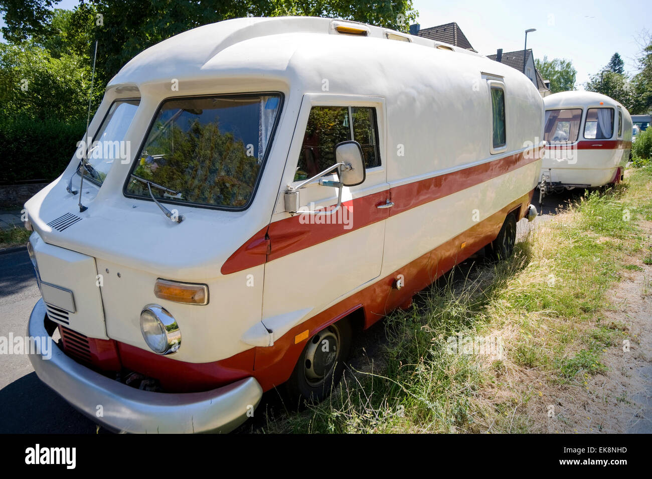 Vintage old-timer camper (RV, recreational vehicle) parking at roadside Stock Photo