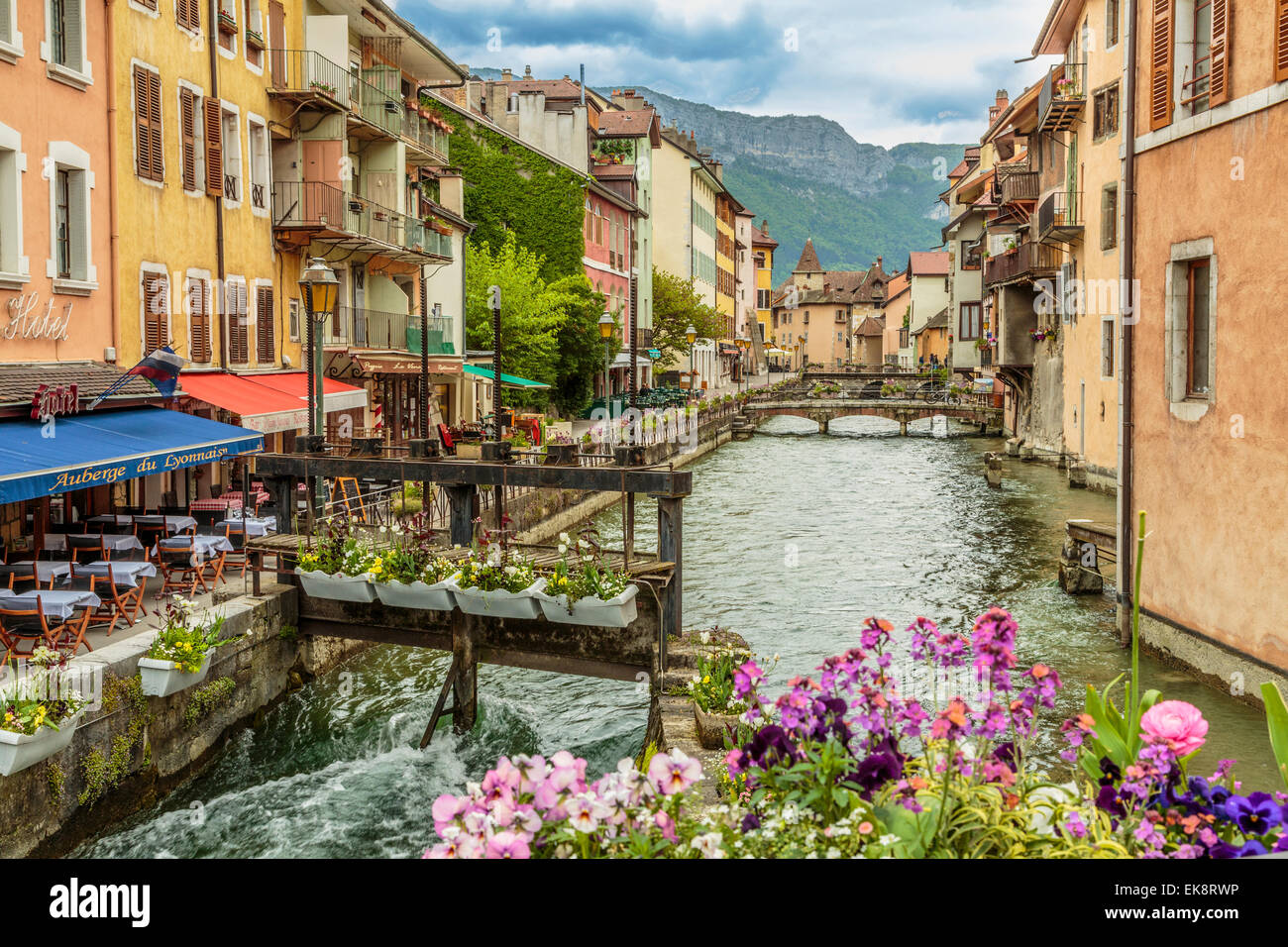 A panoramic landscape image of beautiful and picturesque Annecy old Town with outside restaurant