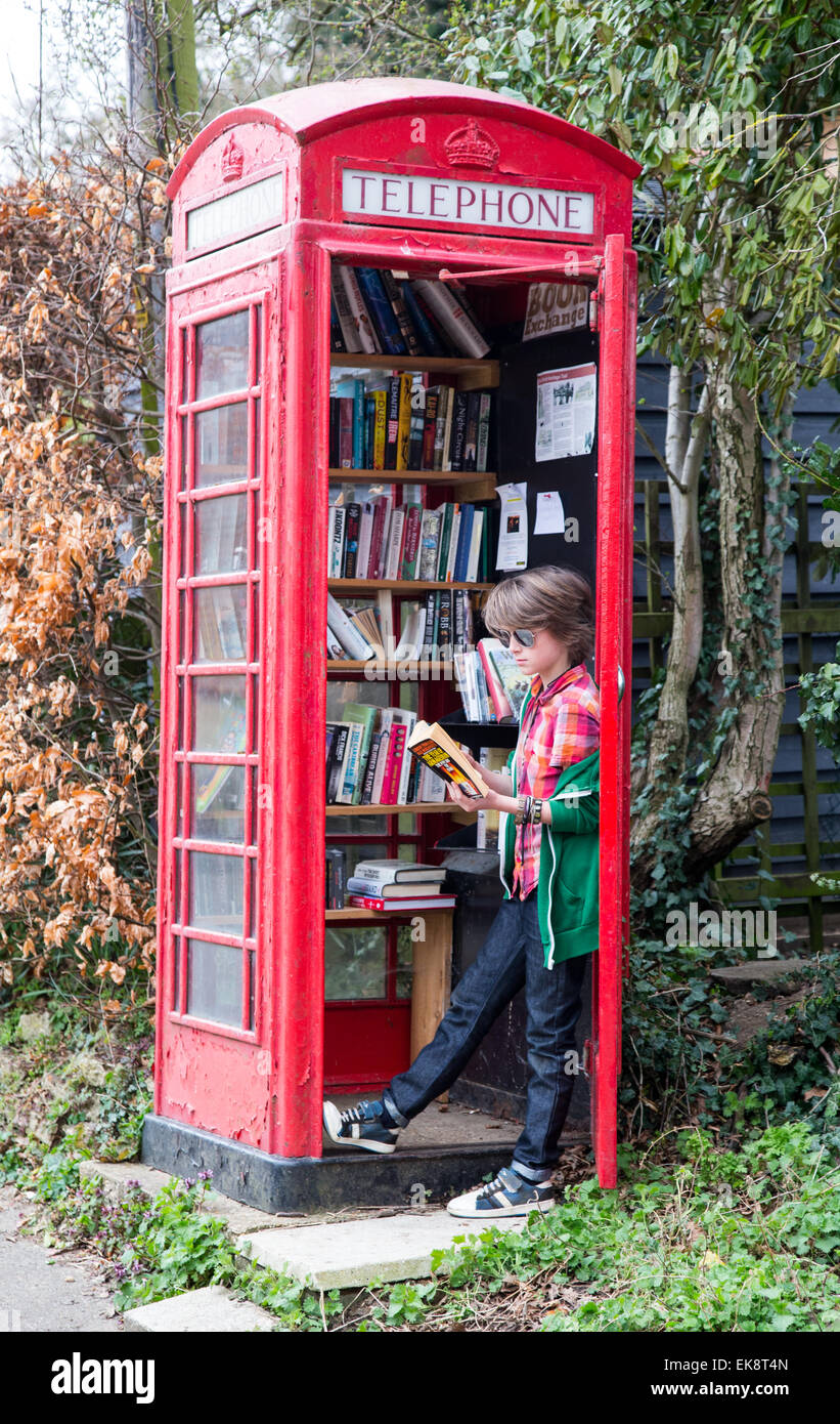 K6 Red telephone box, designed by Sir Giles Gilbert Scott,used as a lending library in a Suffolk village Stock Photo