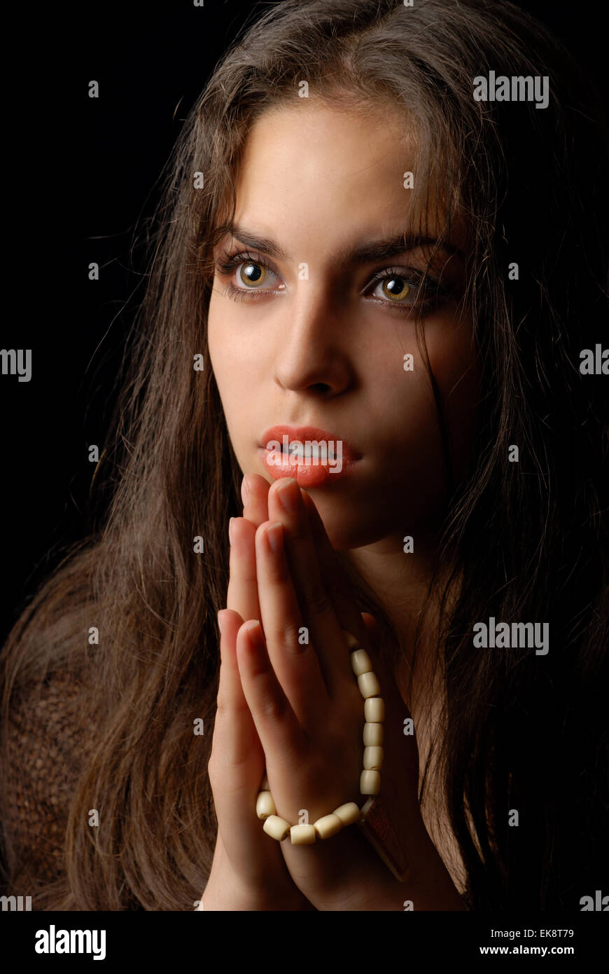 Praying of repentant woman Stock Photo