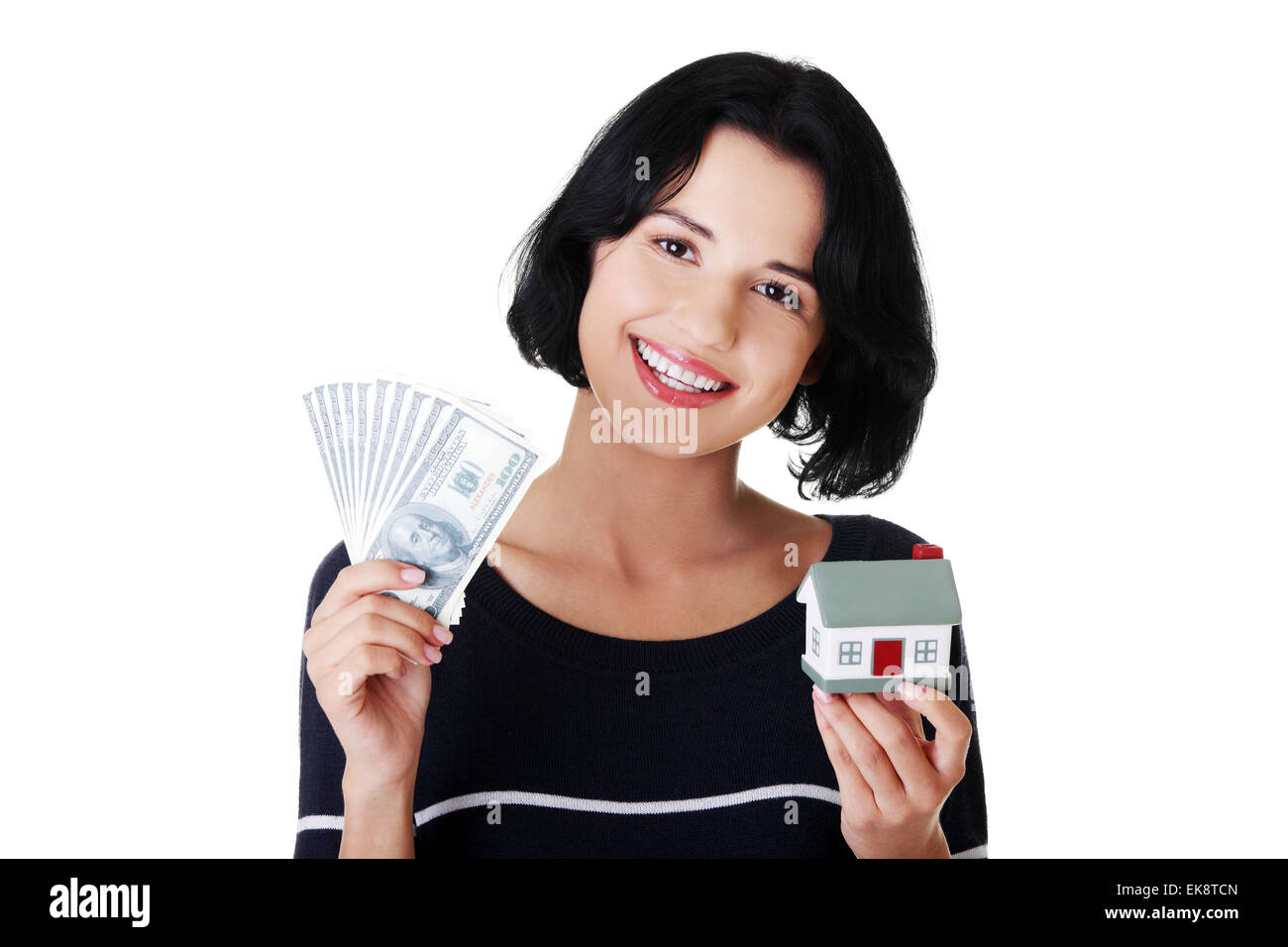 Woman holding US dollars bills and house model Stock Photo