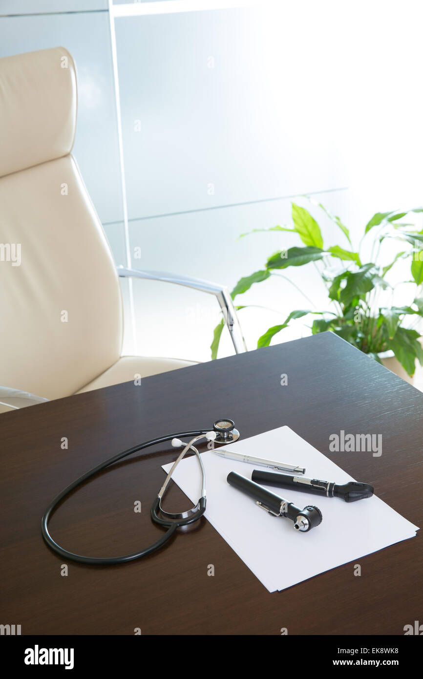 Doctor office table desk with stethoscope and otoscope Stock Photo Alamy