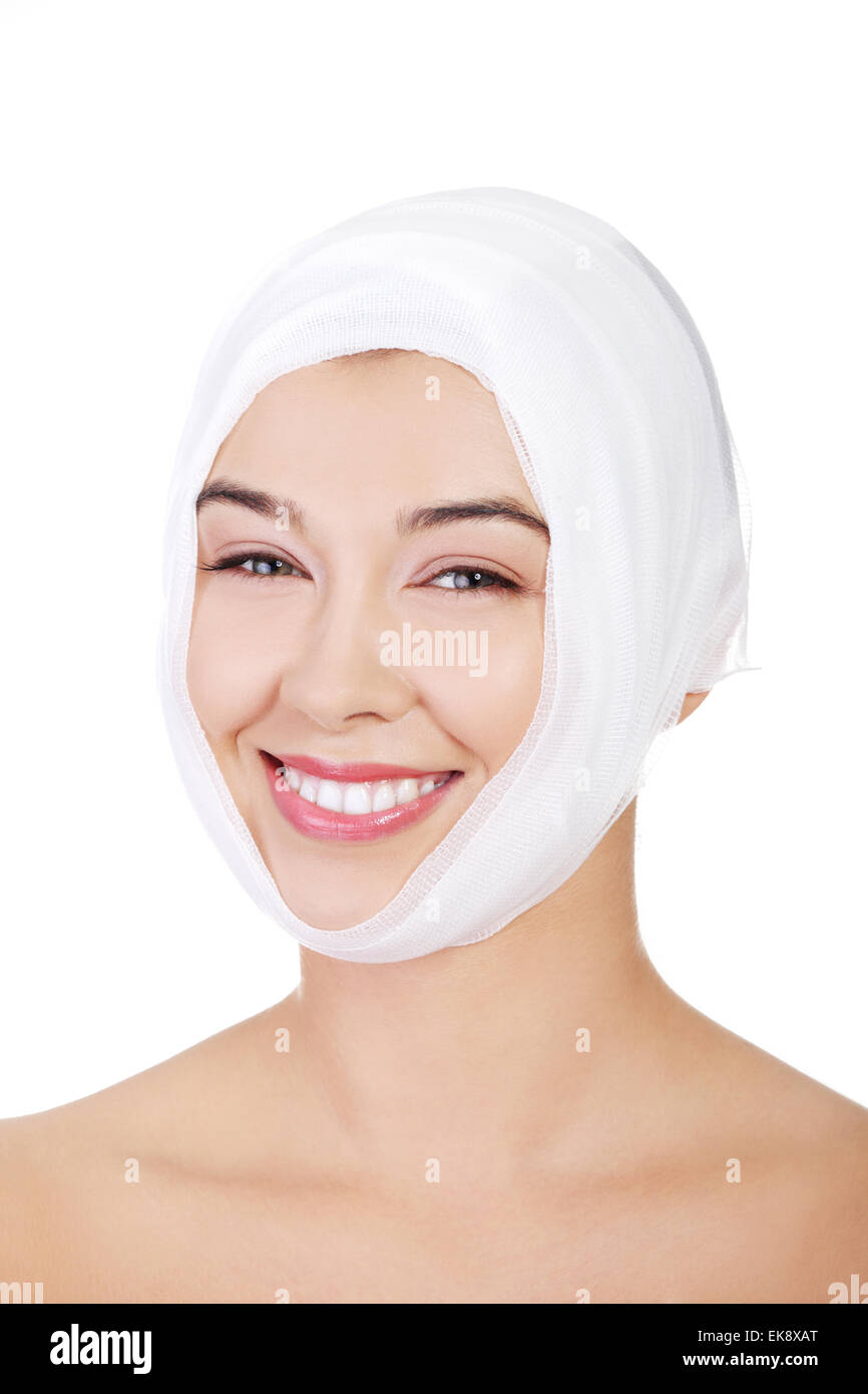 Portrait of beautiful young female face with bandage Stock Photo