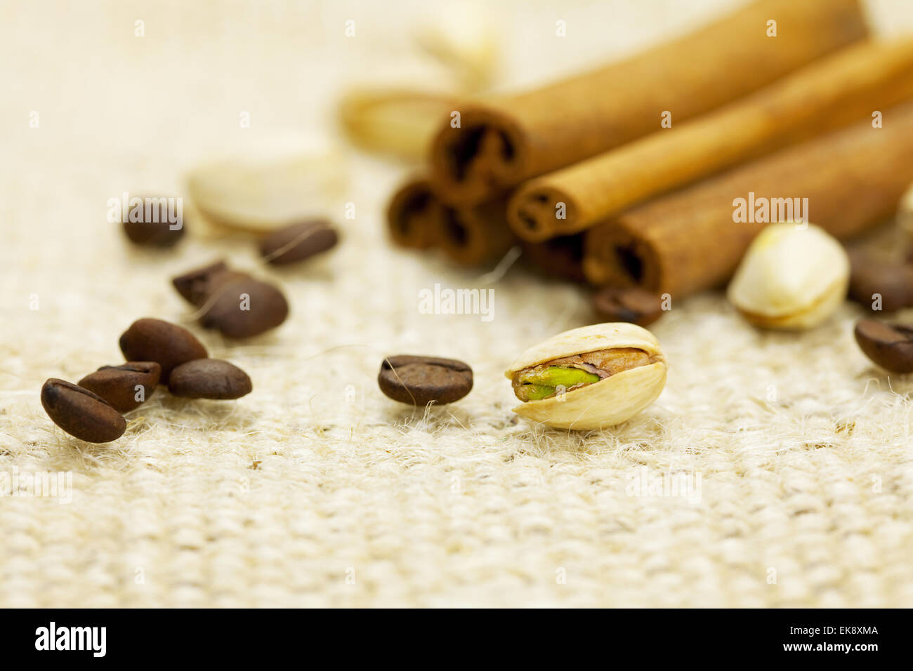 cinnamon, pistachios and coffee beans on the canvas fabric Stock Photo