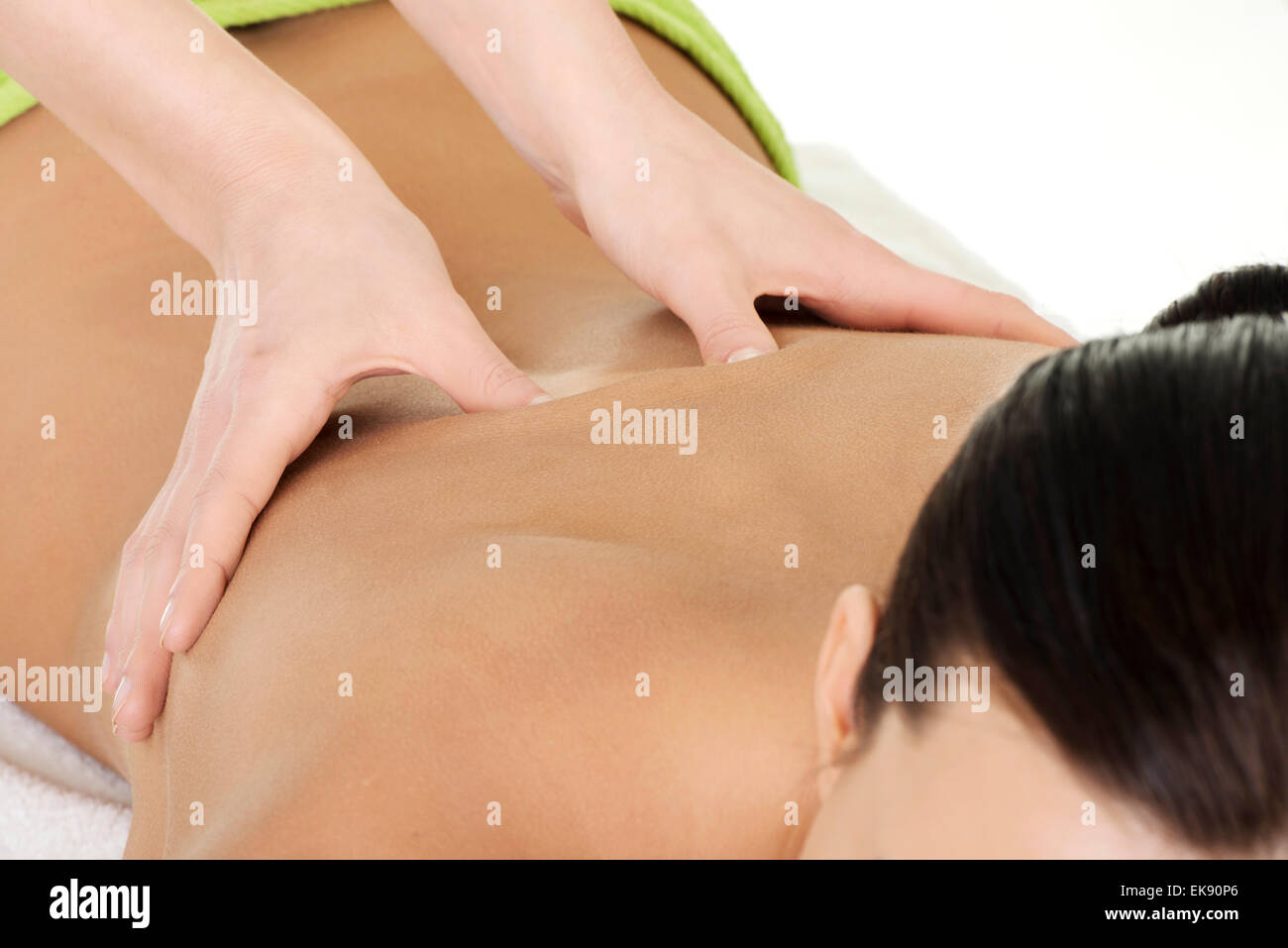 Young woman relaxing beeing massaged in spa saloon Stock Photo