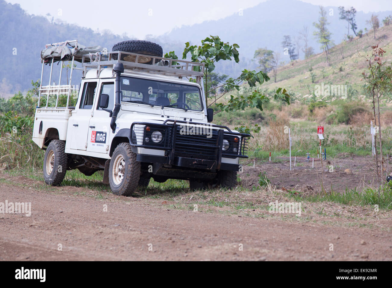 Landrover used by the MAG de-mining team parked by the side of the track next o a minefield in northwestern Cambodia Stock Photo