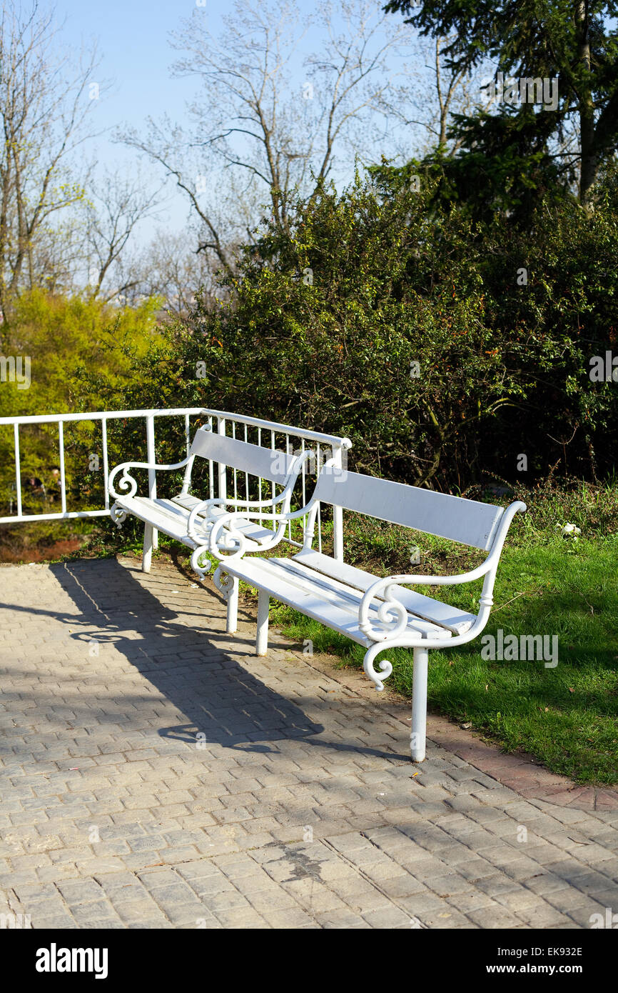 two white benches in the park Stock Photo
