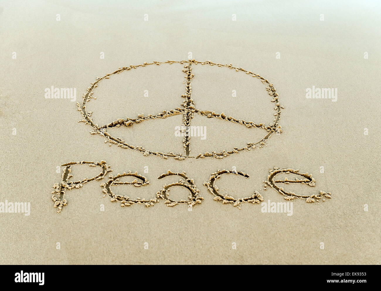 Peace sign drawn in the beach sand. Stock Photo