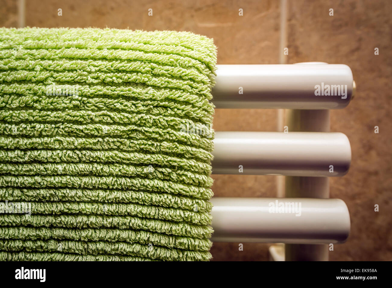Green towel on radiator Stock Photo