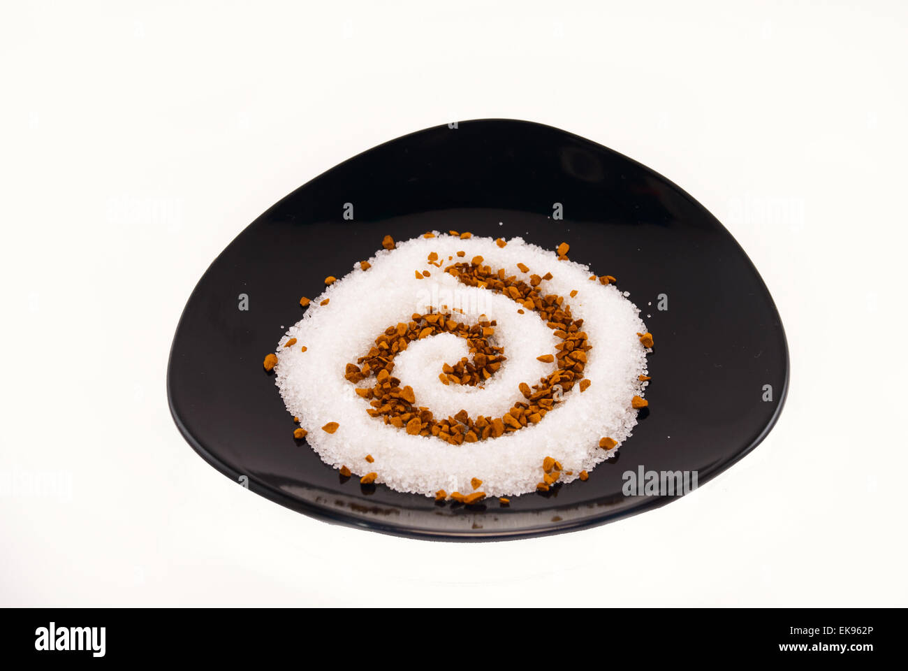 powdered sugar on a black saucer isolated on white Stock Photo
