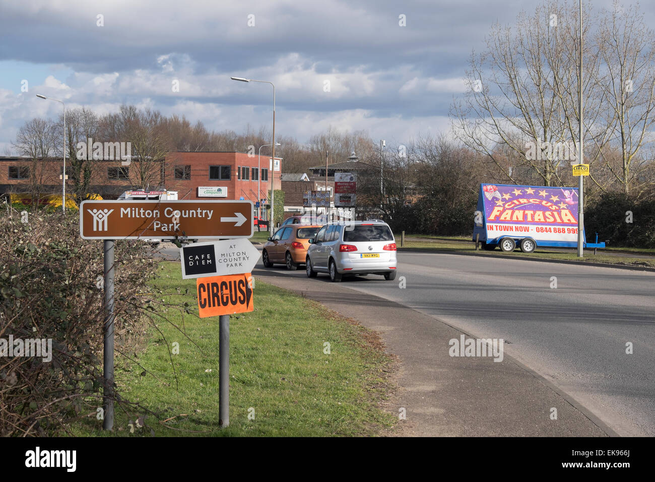 Milton approach slip road to village and circus sign and Big Top Stock Photo