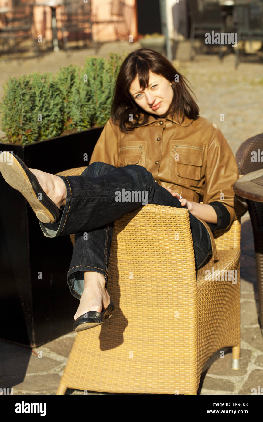 beautiful young woman sitting on a wicker chair Stock Photo - Alamy