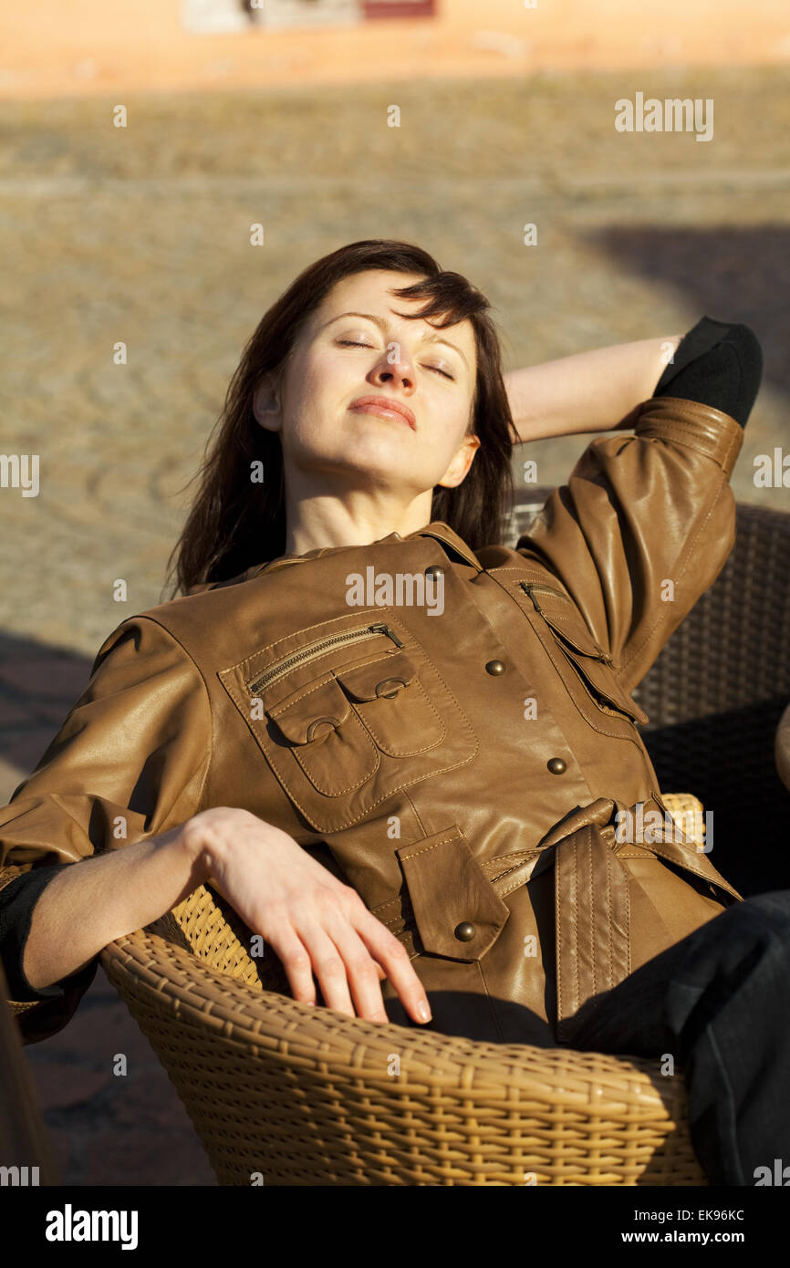 beautiful young woman sitting on a wicker chair Stock Photo - Alamy