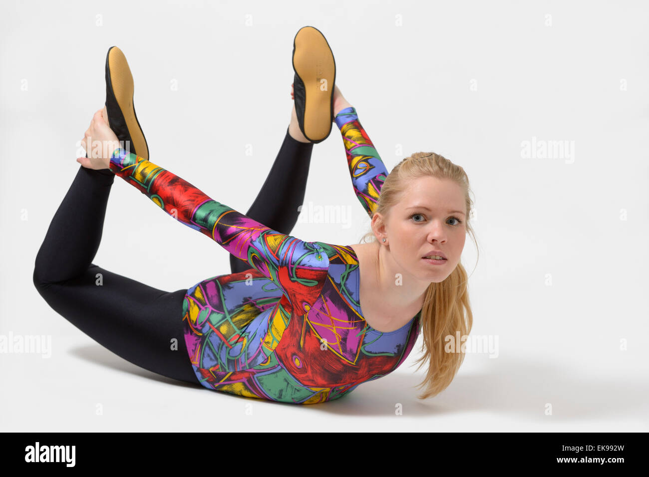 Young woman doing workout. She is wearing a shiny colorful spandex leotard  and leggings Stock Photo - Alamy