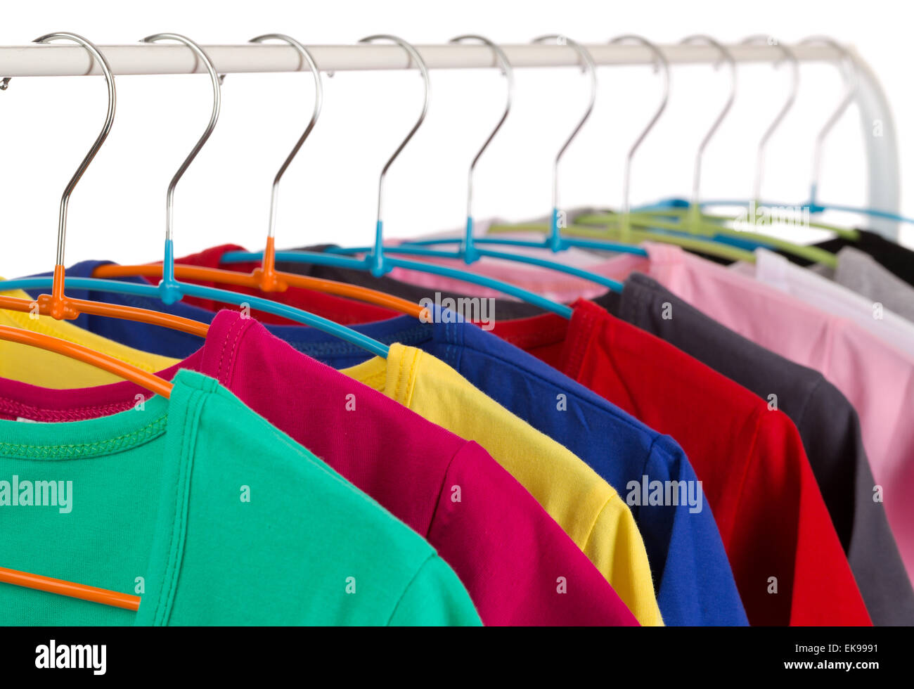 Colorful shirts on hangers, isolate on white. Stock Photo