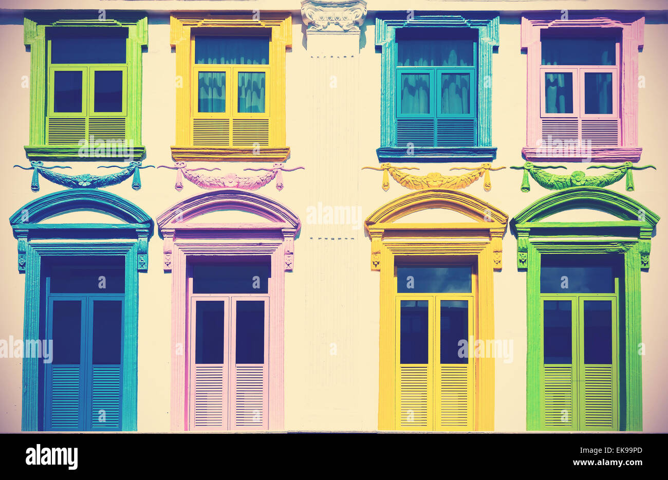 Retro filtered and faded colorful windows and building facade. Stock Photo