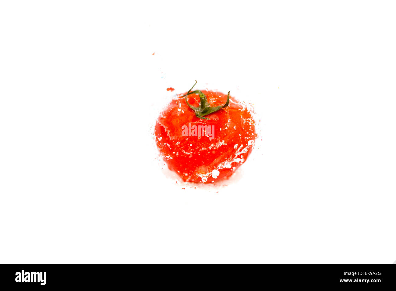 tomatoes with splashes of water isolated on white Stock Photo - Alamy