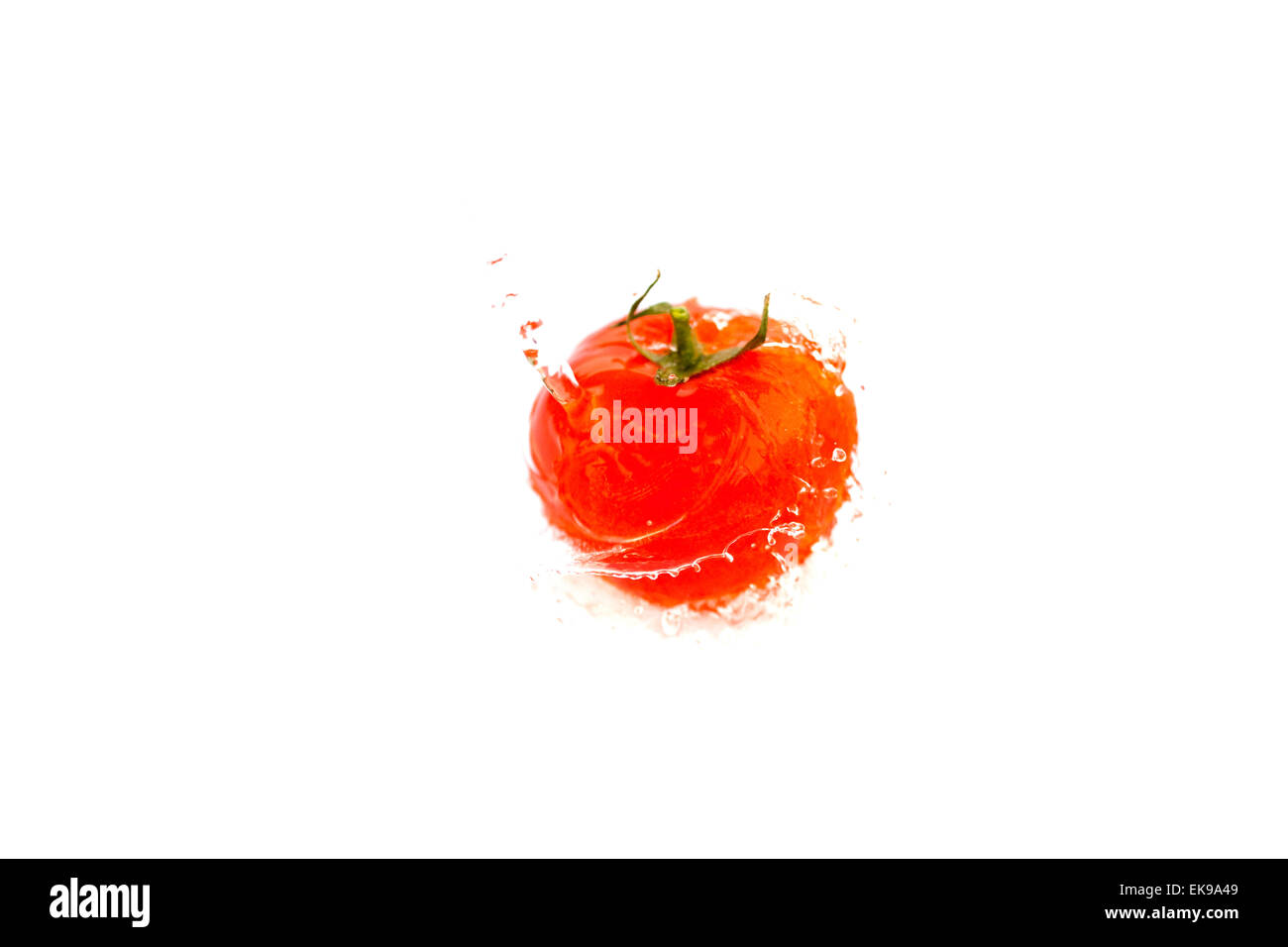 tomatoes with splashes of water isolated on white Stock Photo - Alamy