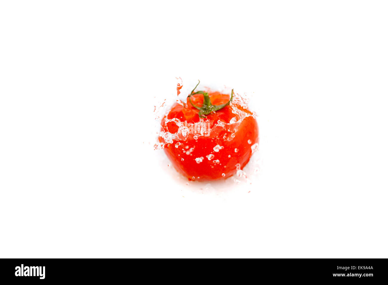 tomatoes with splashes of water isolated on white Stock Photo - Alamy