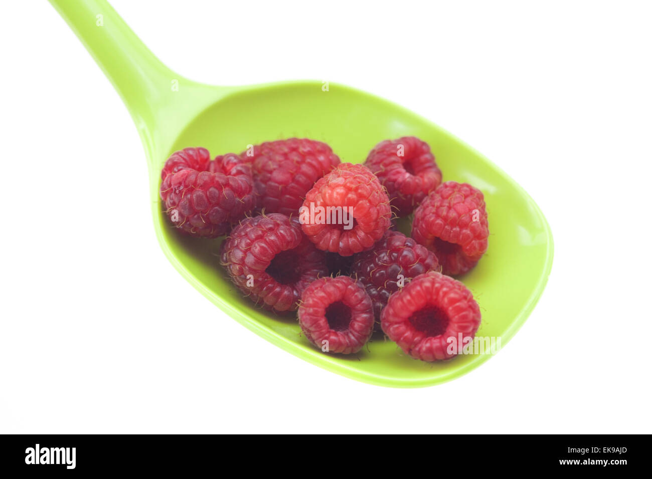 raspberries in a spoon isolated on white Stock Photo - Alamy