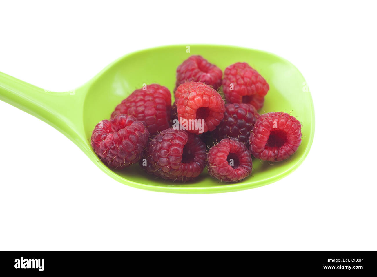 Raspberries in a spoon isolated on white Stock Photo - Alamy