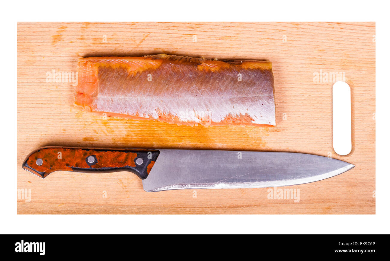 red fish fillet and knife on a wooden board Stock Photo