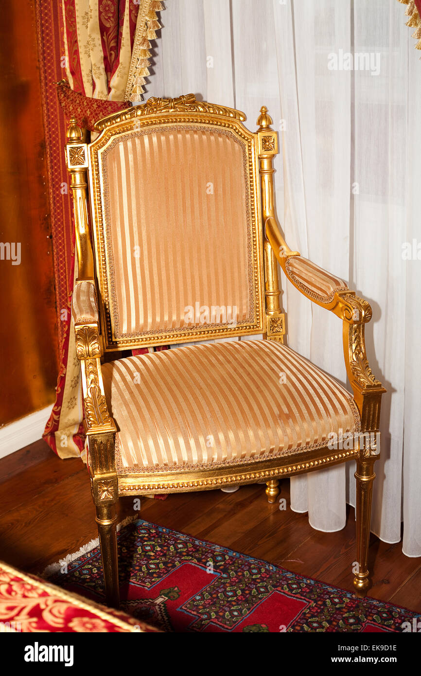 chair in the gold room of the hotel Stock Photo