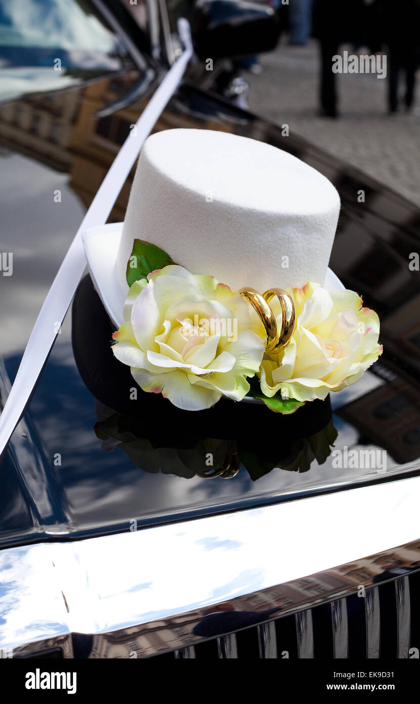 Wedding decoration in the form of hats on the hood of car Stock Photo