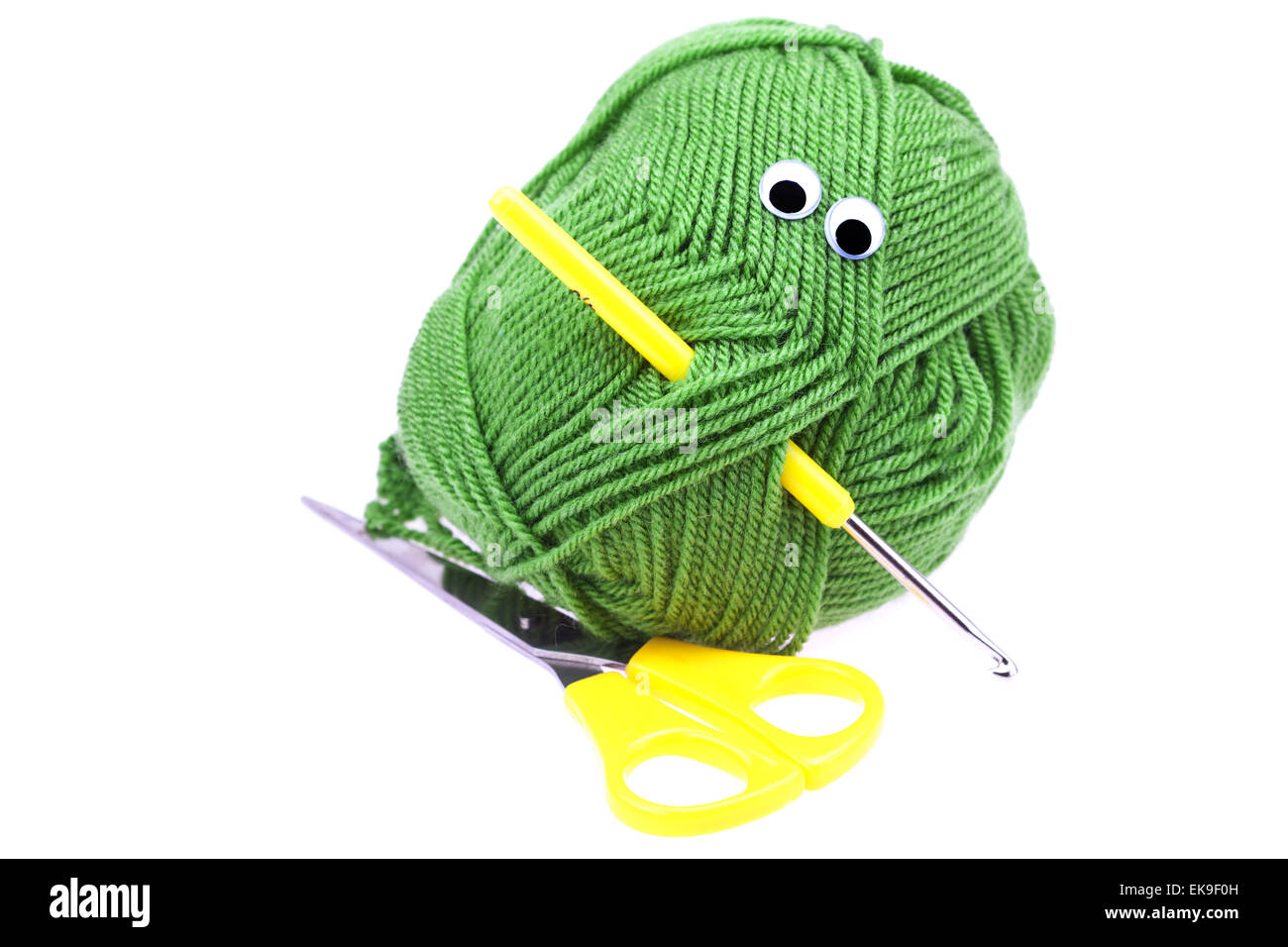 skein of wool  with eyes, scissors and crochet hooks isolated on Stock Photo