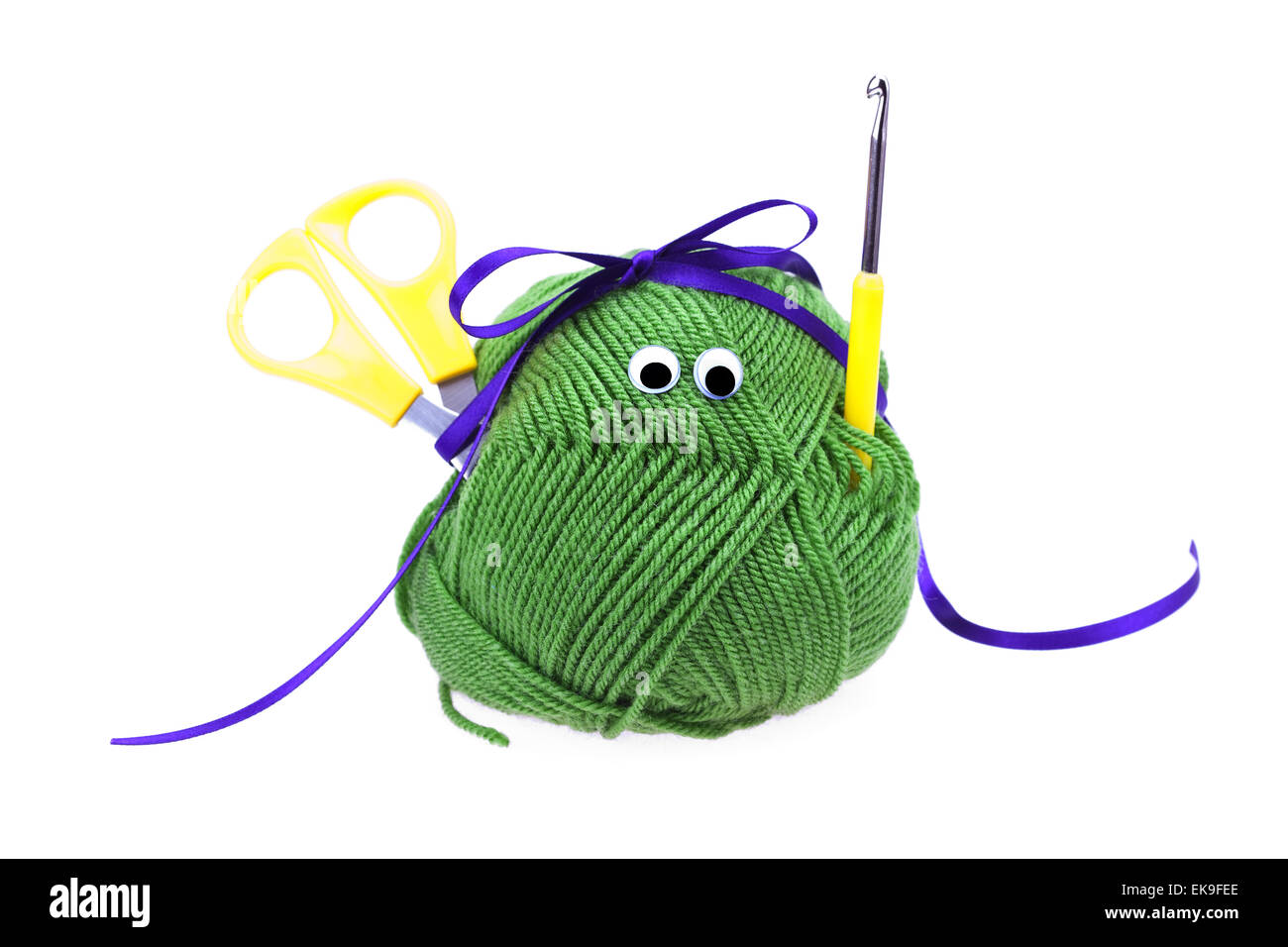 skein of wool with eyes, ribbon, scissors and crochet hooks isol Stock Photo