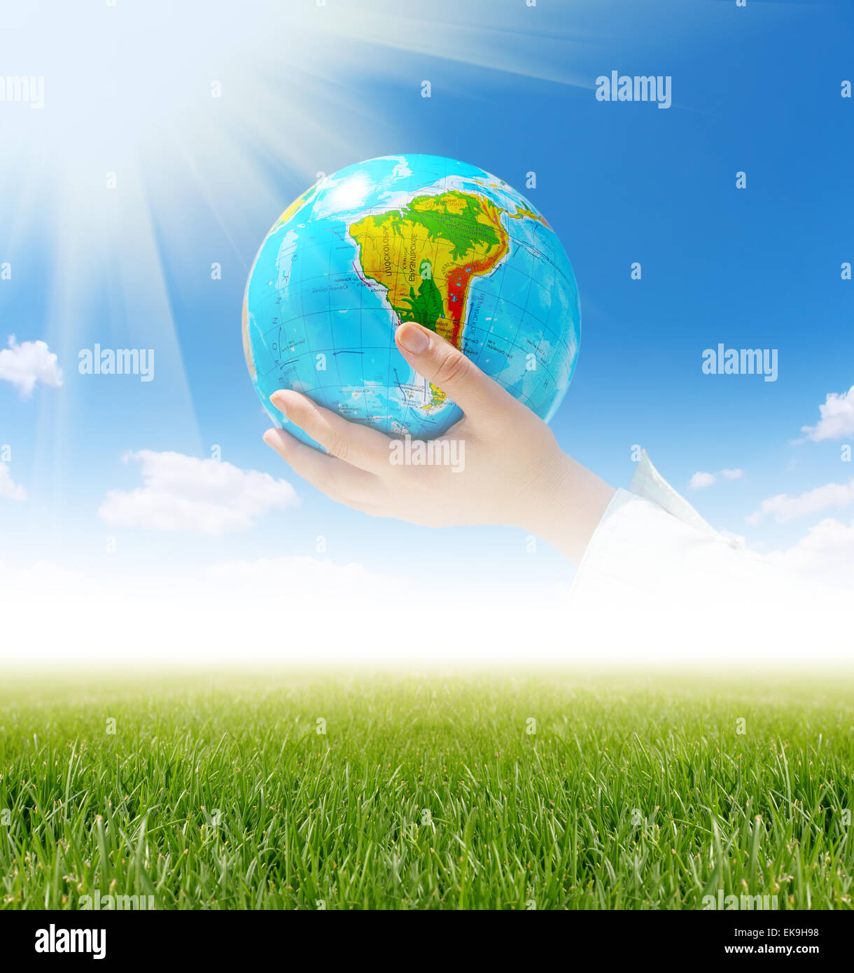 globe in hands under blue sky Stock Photo - Alamy