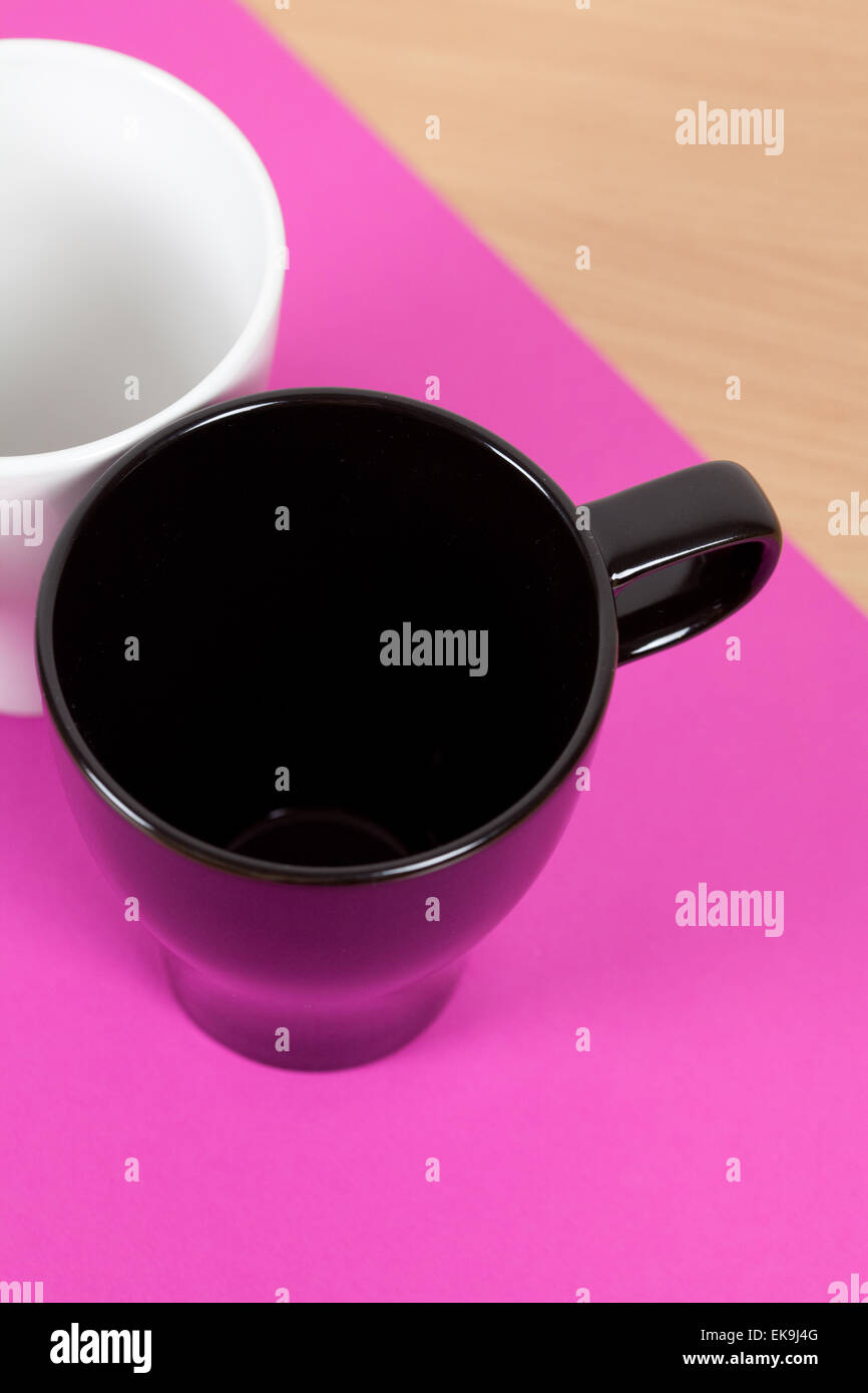 black and white cup standing on a purple background Stock Photo