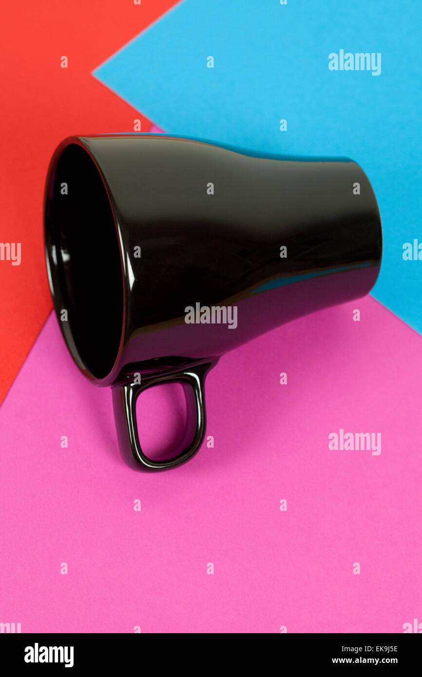 a black cup lying on colorful background Stock Photo