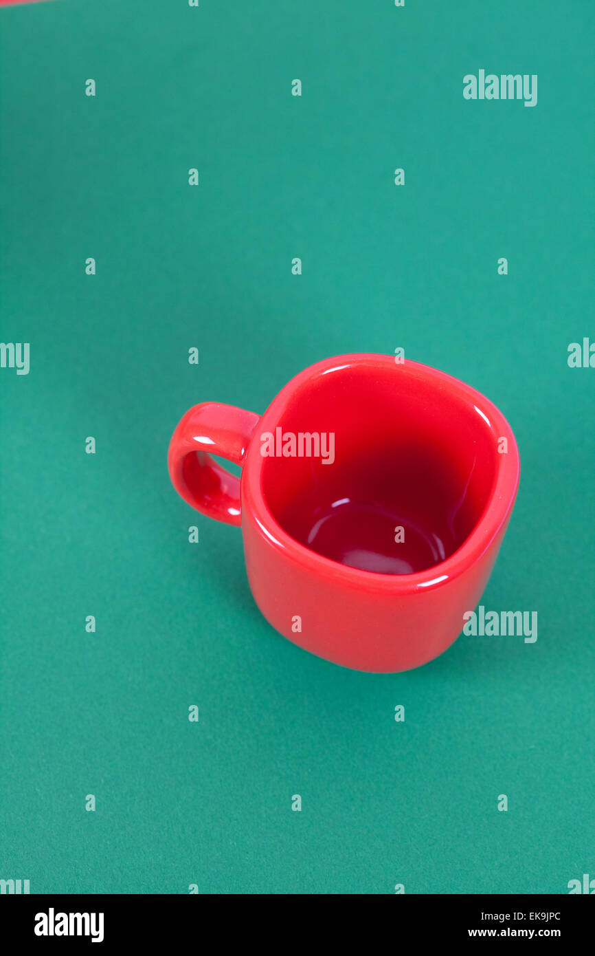 red cup lying on a green background Stock Photo