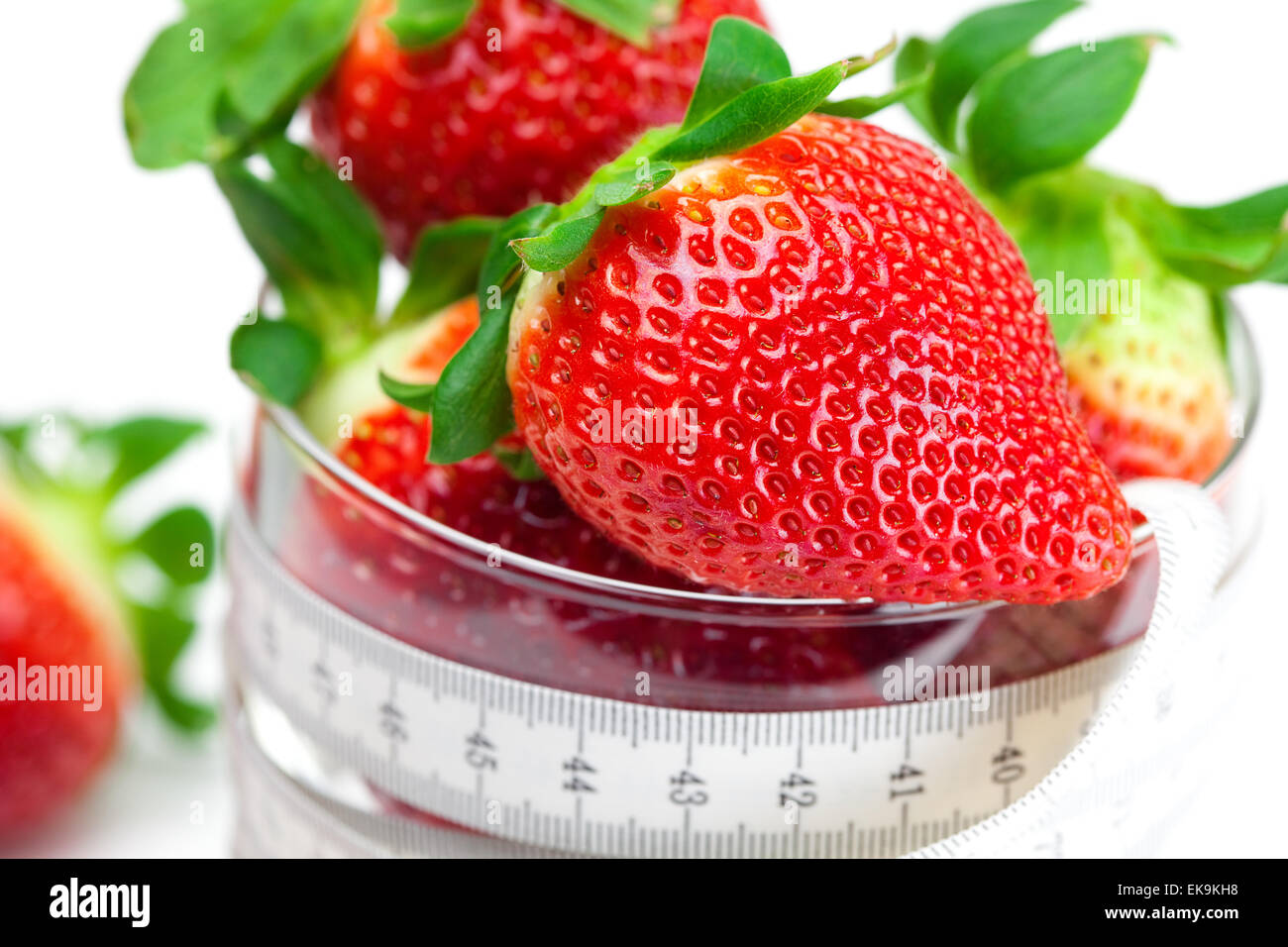 big juicy red ripe strawberries in a glass bowl and measure tape Stock ...