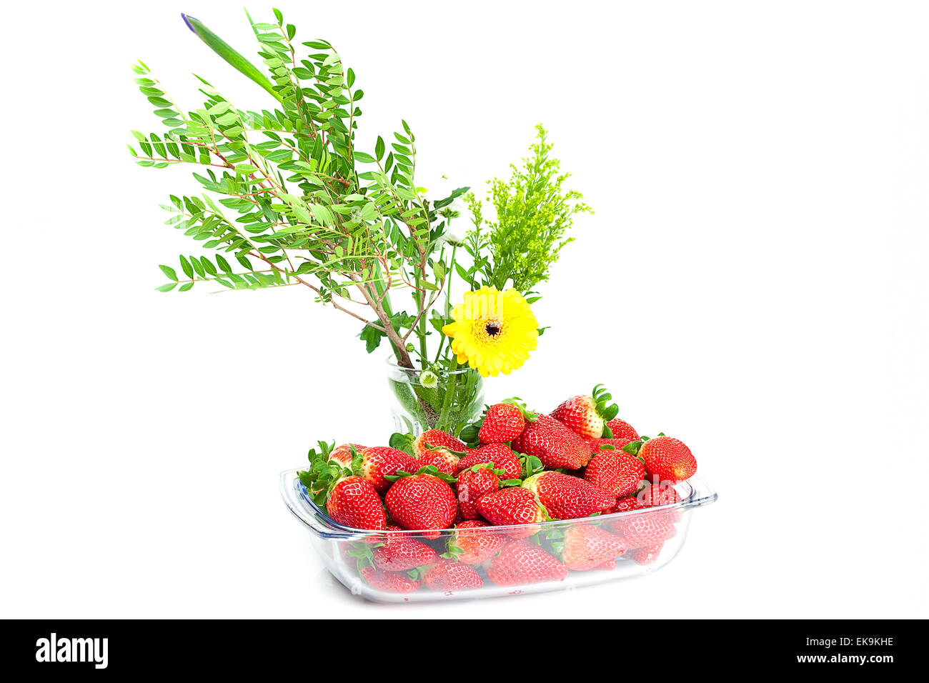 big juicy red ripe strawberries in a glass bowl and flower isola Stock ...