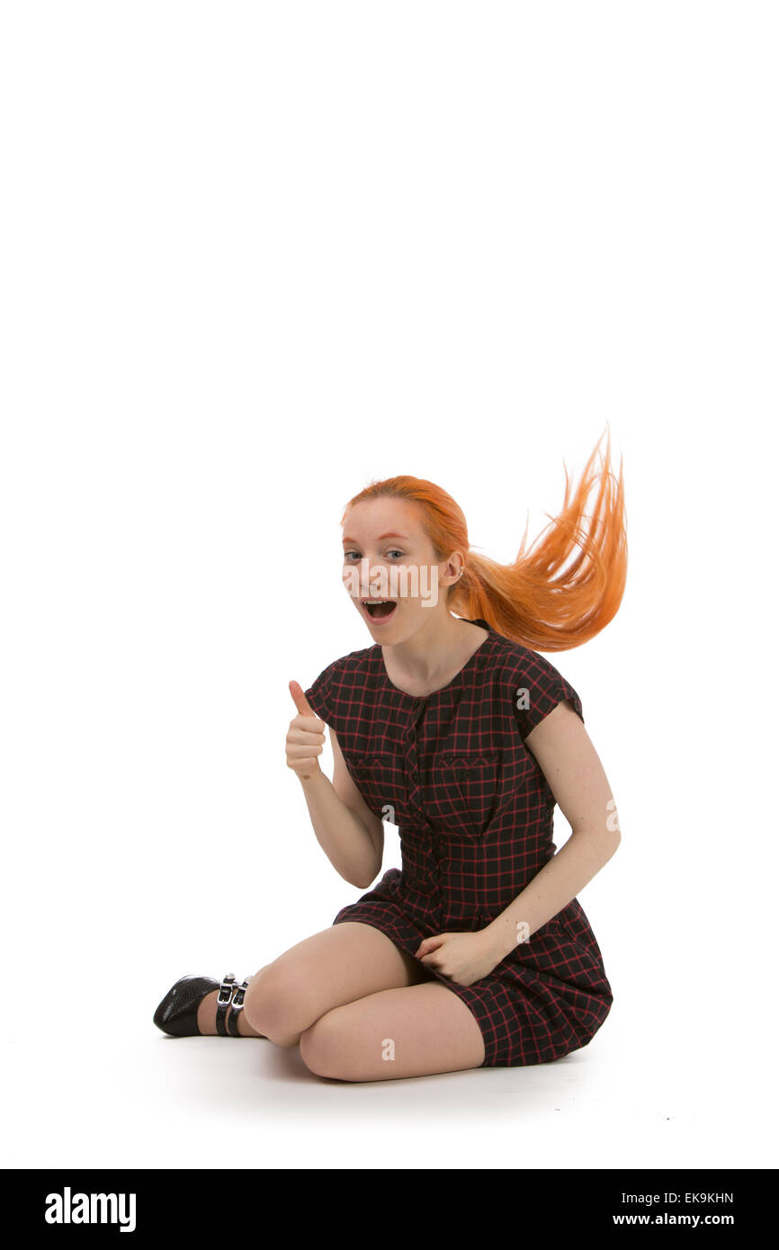 Laughing redhead woman flicking her hair Stock Photo