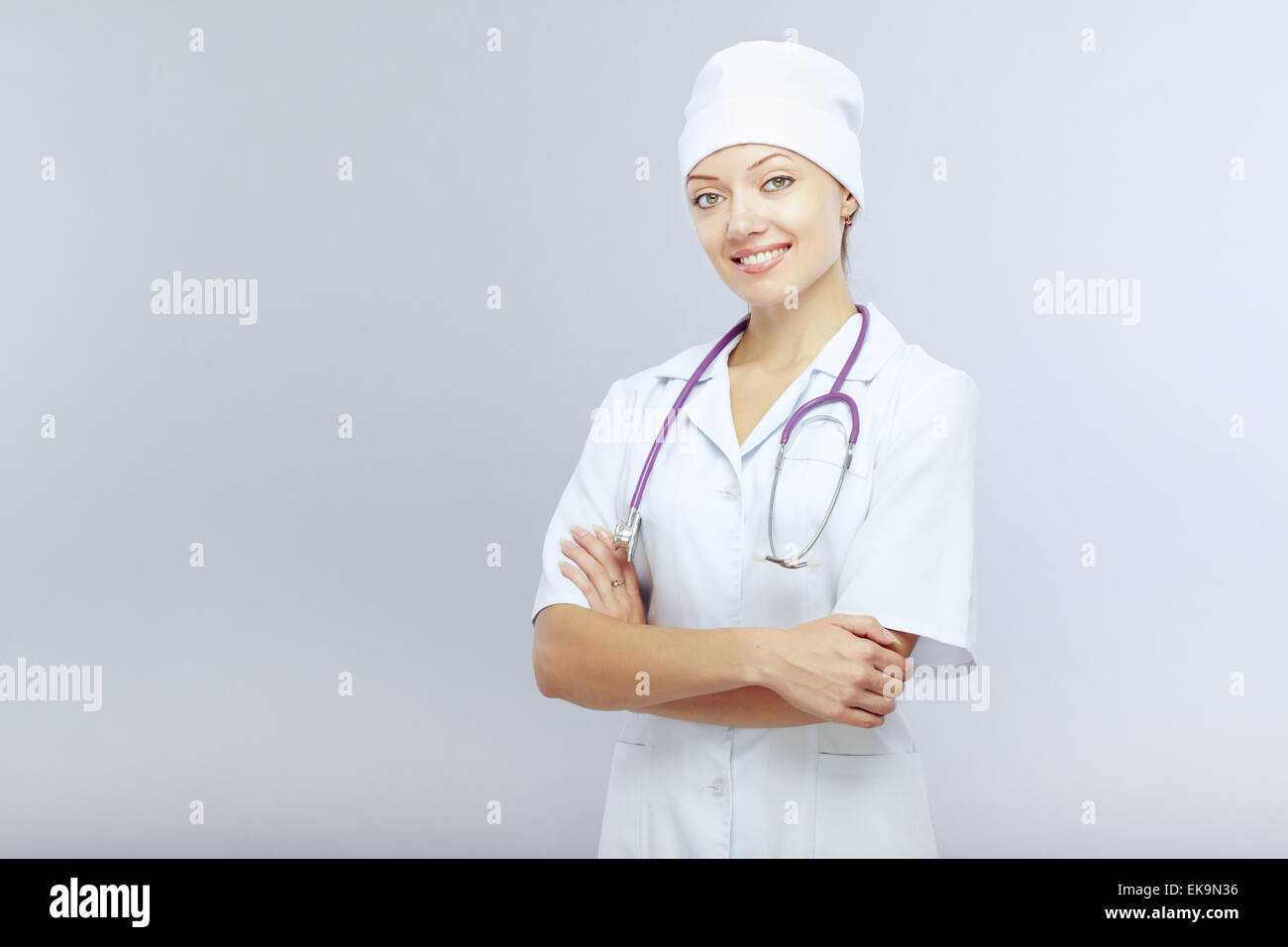 Young smiling doctor on gray hi-res stock photography and images - Alamy